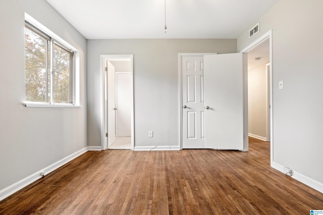 unfurnished bedroom with wood-type flooring