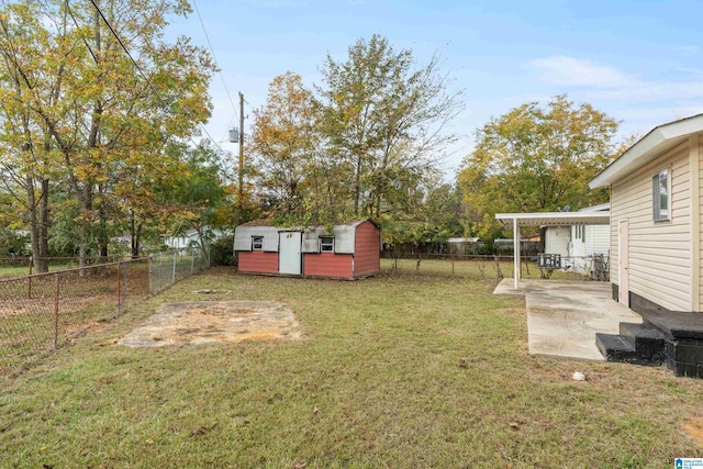 view of yard featuring a storage unit and a patio