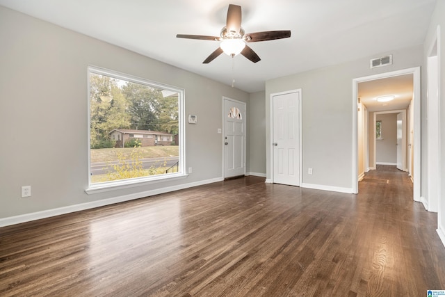 unfurnished living room with dark wood-type flooring and ceiling fan