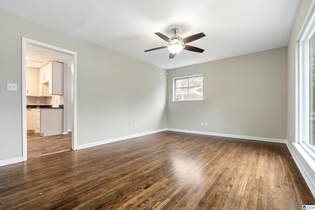 spare room featuring dark hardwood / wood-style floors and ceiling fan