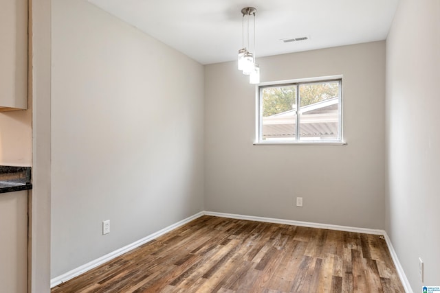 unfurnished dining area with dark hardwood / wood-style flooring