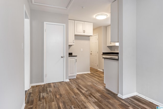 kitchen featuring white cabinetry and dark hardwood / wood-style floors