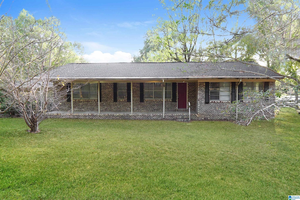 ranch-style home with a front lawn