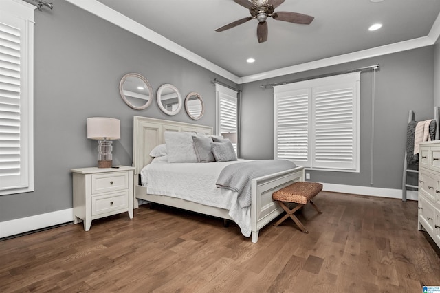 bedroom with dark hardwood / wood-style flooring, ornamental molding, and ceiling fan