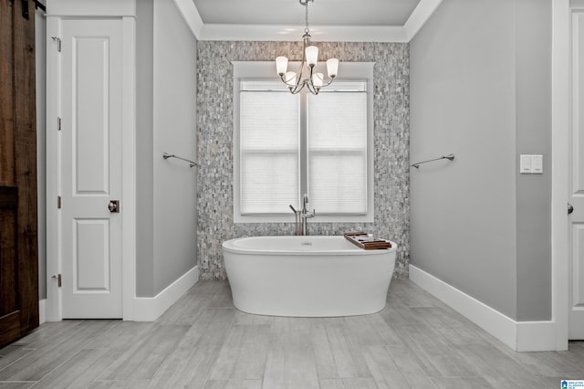 bathroom featuring wood-type flooring, an inviting chandelier, and a bathing tub