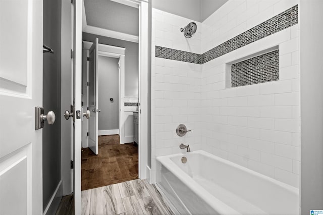 bathroom featuring tiled shower / bath combo and hardwood / wood-style flooring