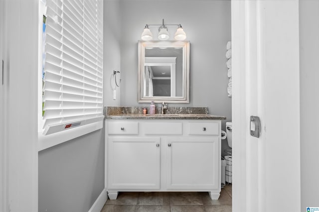 bathroom featuring vanity, toilet, and tile patterned floors