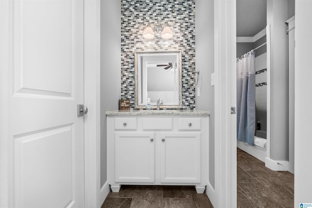 bathroom with vanity, crown molding, decorative backsplash, and curtained shower