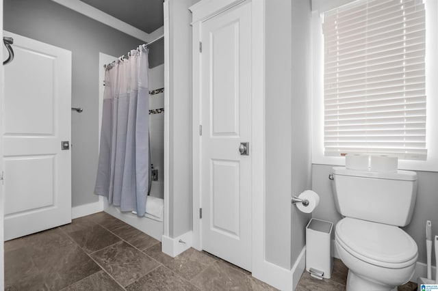 bathroom featuring toilet and a shower with shower curtain