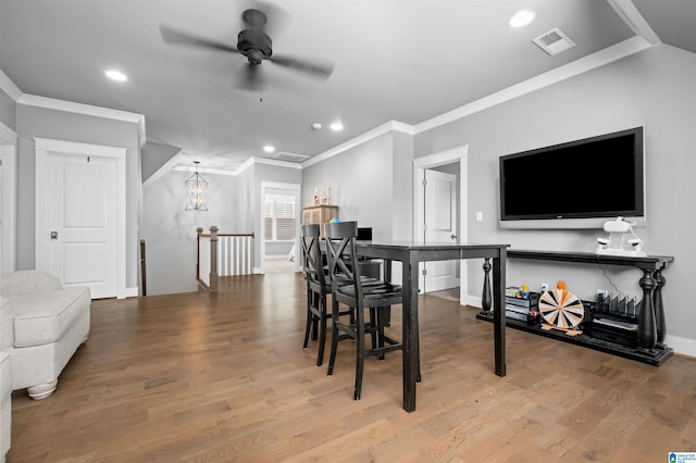 dining space with crown molding, light hardwood / wood-style floors, and ceiling fan