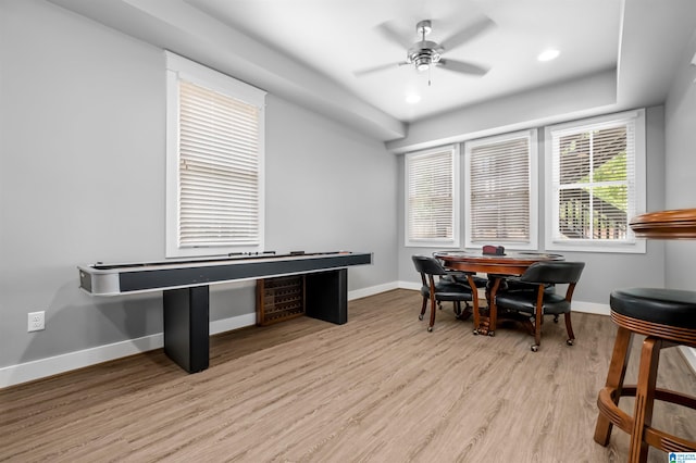 dining area with light wood-type flooring and ceiling fan