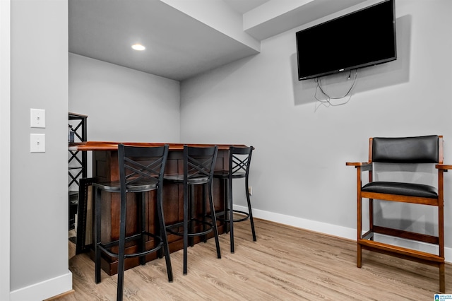 bar featuring light hardwood / wood-style flooring