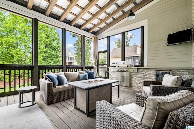 sunroom / solarium featuring vaulted ceiling with beams and a wealth of natural light