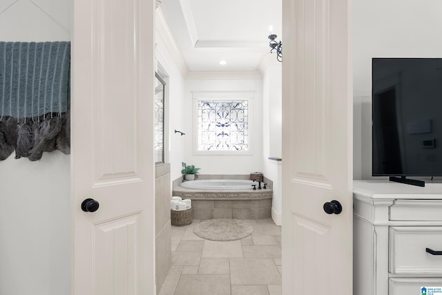 bathroom with a relaxing tiled tub and tile patterned flooring