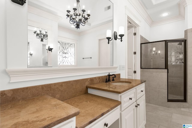 bathroom with tile patterned floors, ornamental molding, an inviting chandelier, vanity, and walk in shower