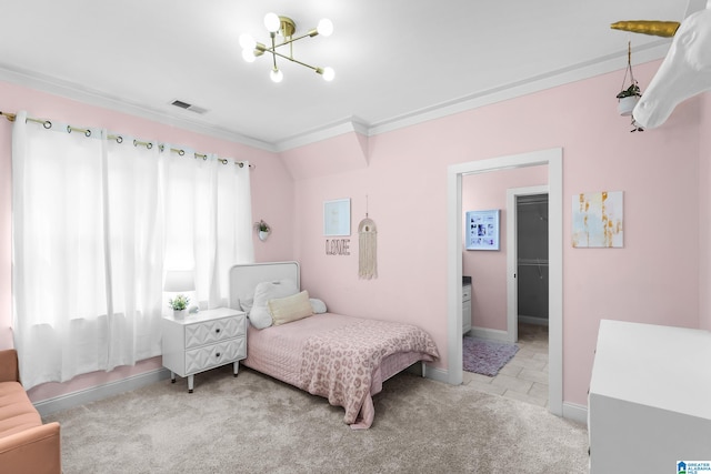 carpeted bedroom featuring ornamental molding, ensuite bathroom, and a chandelier