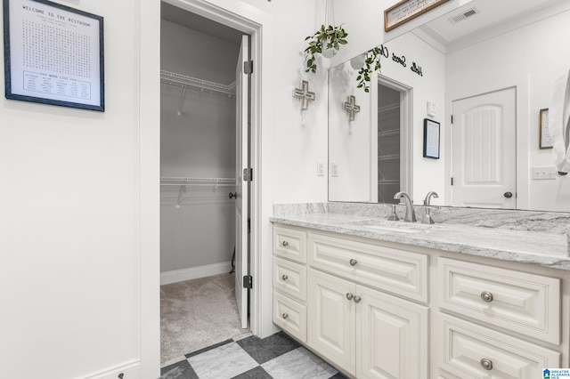 bathroom with vanity and ornamental molding