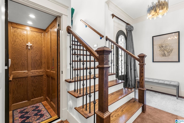 stairway featuring ornamental molding, a chandelier, and elevator