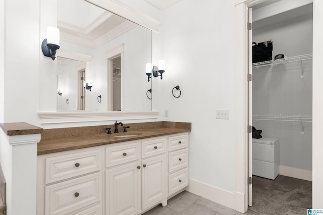 bathroom with vanity, ornamental molding, and tile patterned flooring