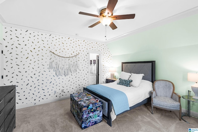 carpeted bedroom with lofted ceiling, crown molding, and ceiling fan