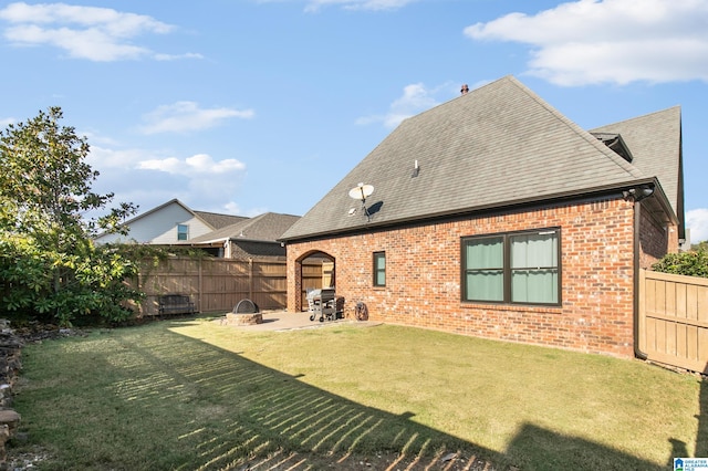 back of property with a yard and a patio