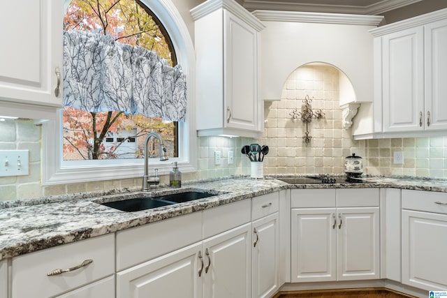 kitchen featuring sink and white cabinetry