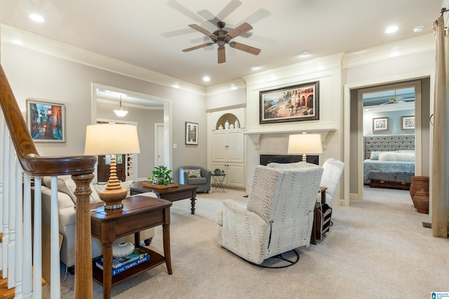 living room with crown molding, light colored carpet, and ceiling fan