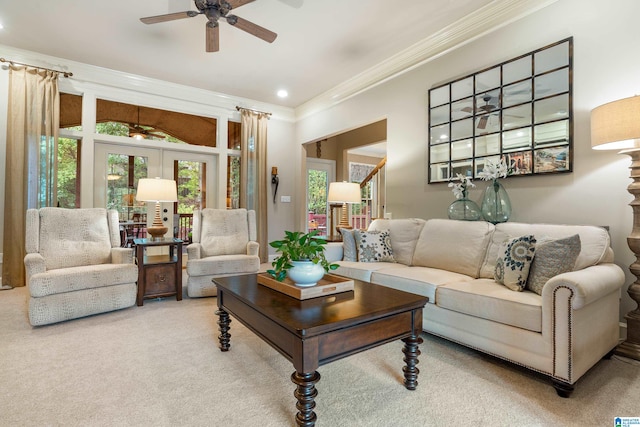 living room featuring french doors, carpet flooring, ornamental molding, and ceiling fan