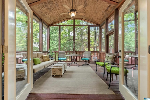 sunroom / solarium featuring vaulted ceiling, wooden ceiling, and ceiling fan