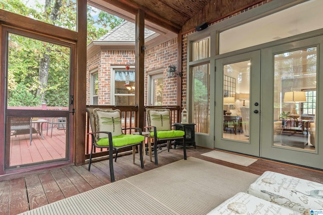 sunroom / solarium with french doors, lofted ceiling, and a wealth of natural light