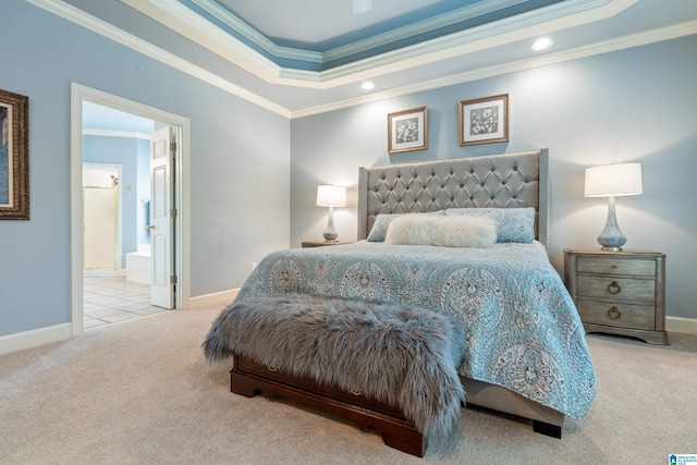 bedroom featuring ornamental molding, ensuite bathroom, and light colored carpet