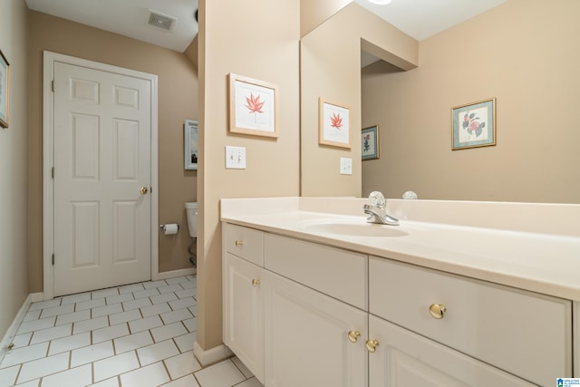 bathroom with vanity, toilet, and tile patterned flooring