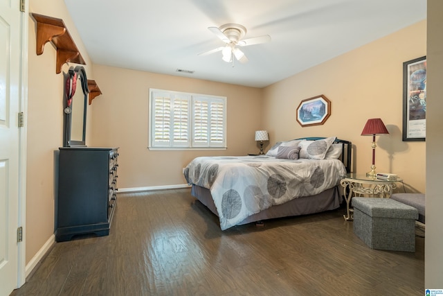 bedroom with dark hardwood / wood-style flooring and ceiling fan