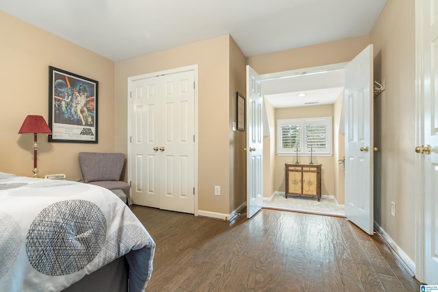 bedroom with a closet and dark hardwood / wood-style flooring