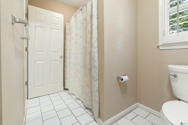 bathroom featuring toilet, a shower with shower curtain, and tile patterned flooring