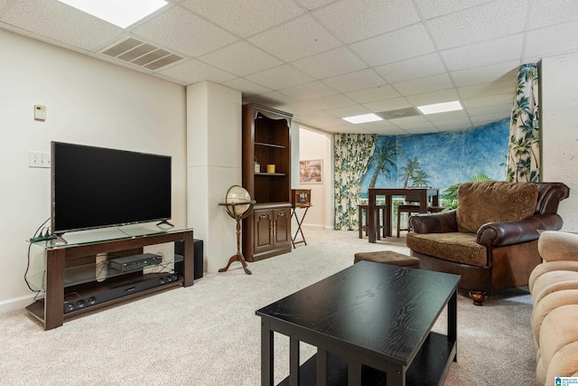 living room featuring a paneled ceiling and light colored carpet