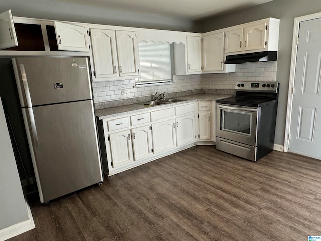 kitchen with appliances with stainless steel finishes, sink, dark hardwood / wood-style flooring, white cabinetry, and decorative backsplash