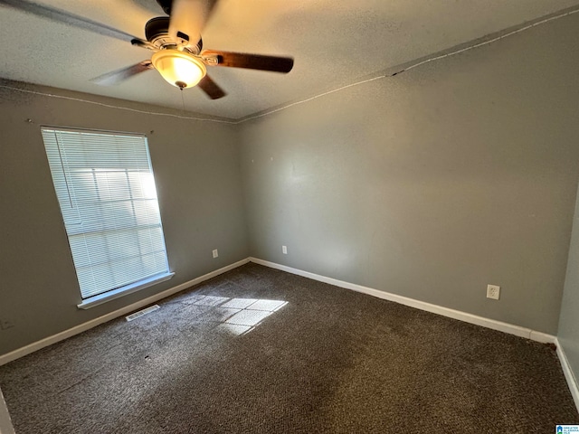 spare room featuring a textured ceiling, carpet floors, and ceiling fan