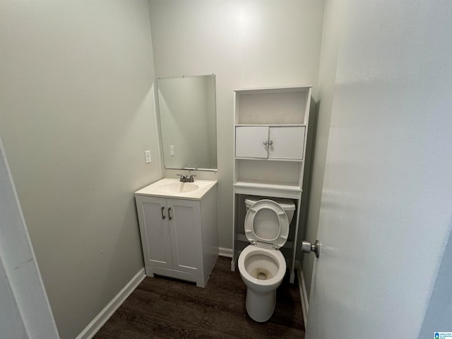 bathroom featuring vanity, hardwood / wood-style flooring, and toilet