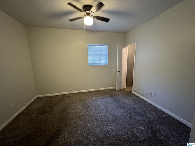 carpeted spare room featuring a ceiling fan, baseboards, and a textured ceiling