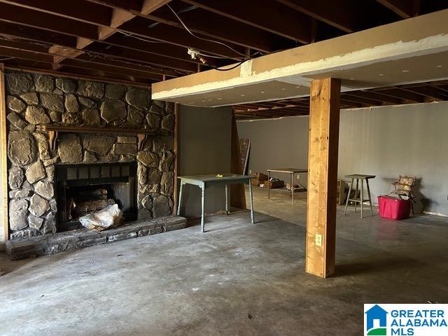 basement featuring a stone fireplace