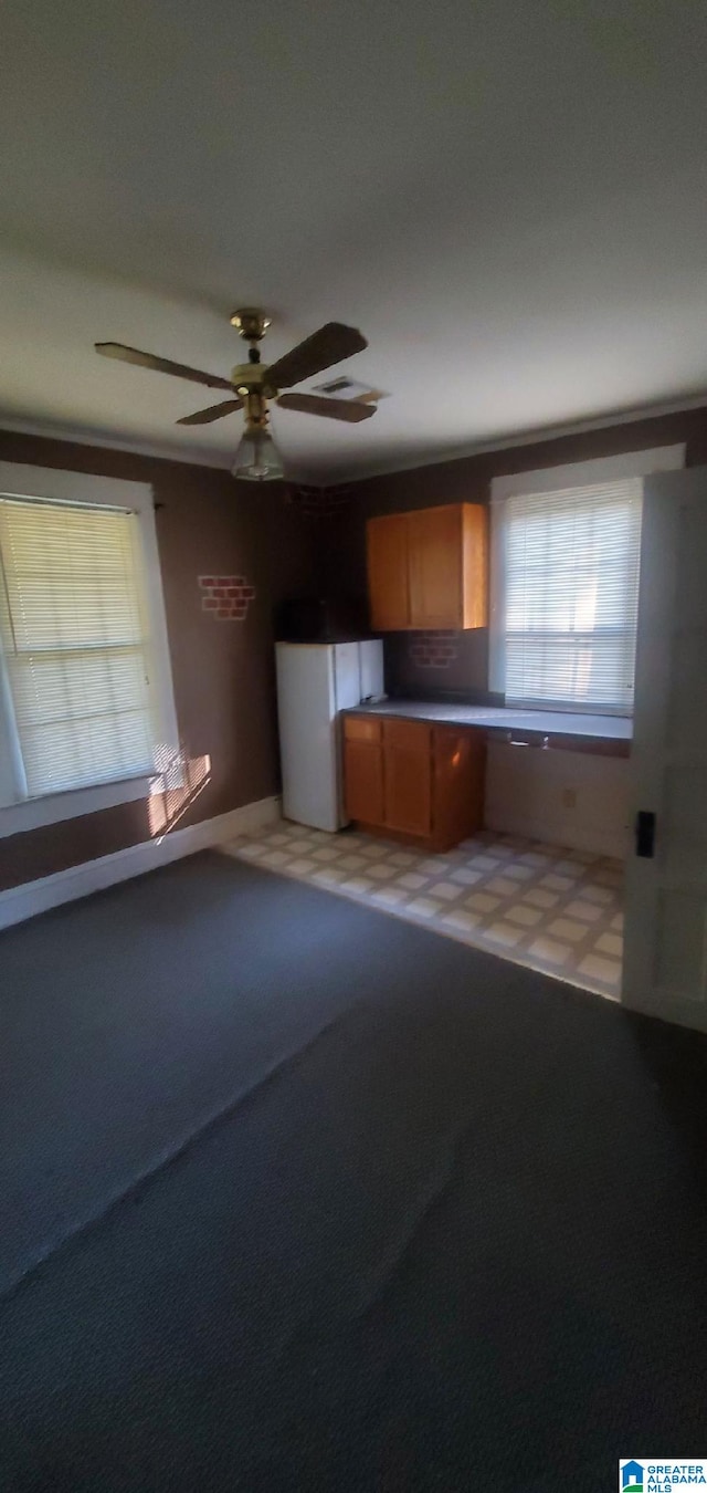 kitchen featuring ceiling fan, carpet flooring, and white refrigerator