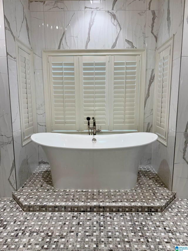 full bath featuring a freestanding bath and tile walls