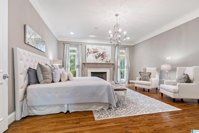 bedroom with ornamental molding, multiple windows, a fireplace, and wood finished floors