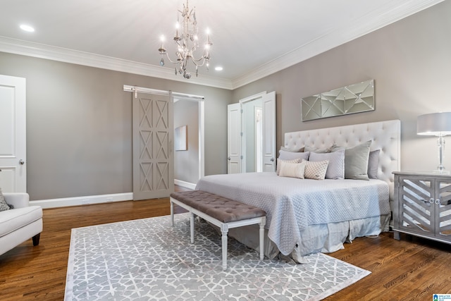 bedroom featuring a barn door, baseboards, wood finished floors, and ornamental molding