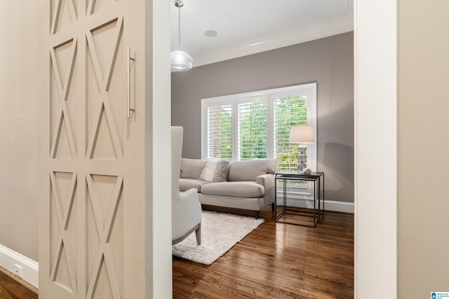 interior space featuring dark wood-style flooring, crown molding, and baseboards