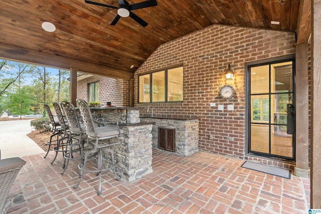 view of patio / terrace featuring ceiling fan, exterior kitchen, and outdoor wet bar