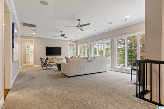 living room featuring ornamental molding, carpet, visible vents, and baseboards