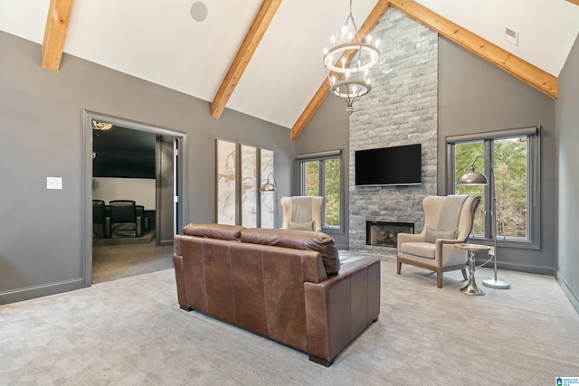 living room with visible vents, an inviting chandelier, carpet flooring, a stone fireplace, and high vaulted ceiling