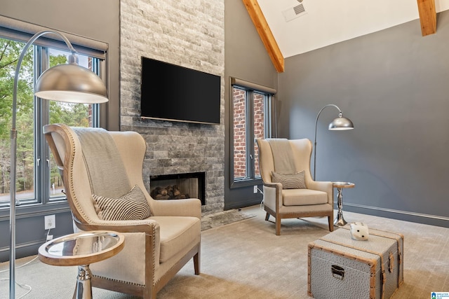 sitting room featuring baseboards, visible vents, carpet floors, a fireplace, and high vaulted ceiling